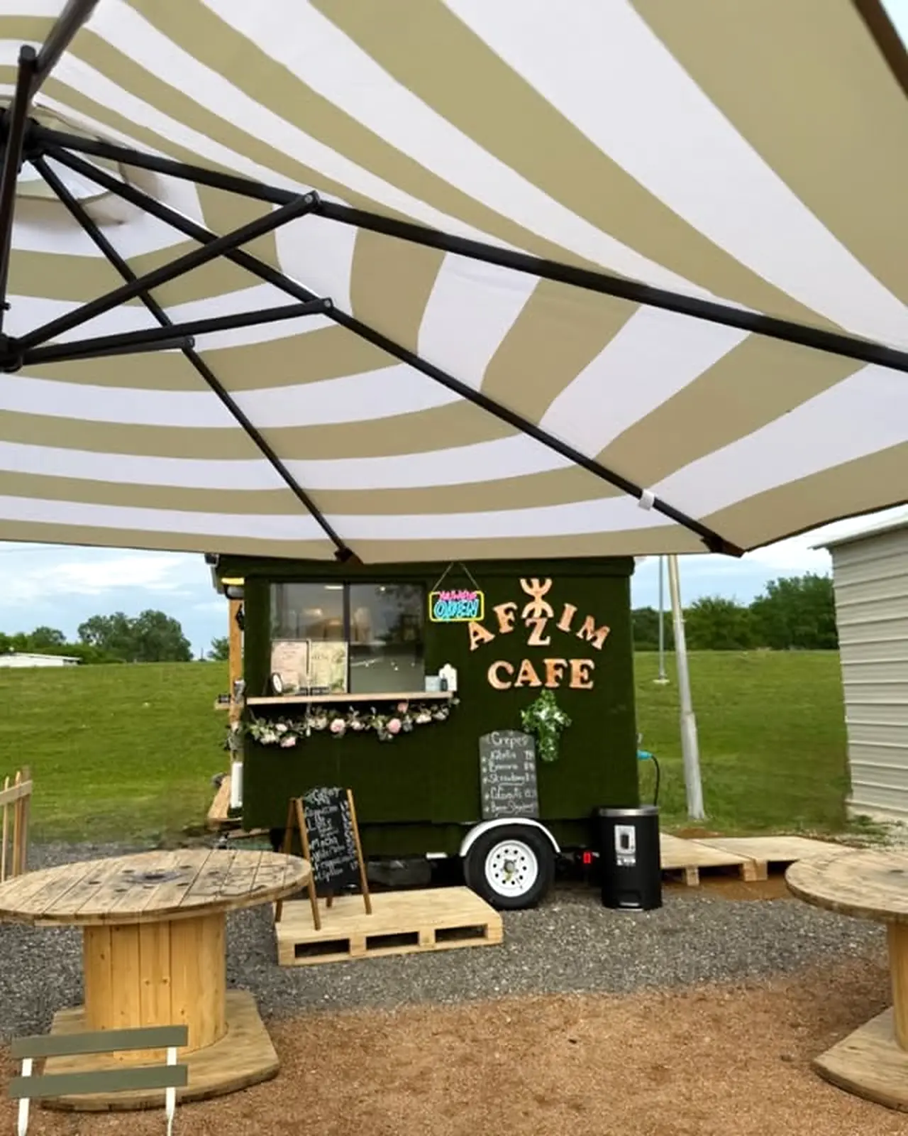 Afzim Cafe trailer and outdoor seating at 982 Food Yard